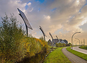 Solar panels along a small road and a European village in the backgroundCO2mmunity - a project of Interreg Baltic Sea Region (photo: Panthermedia)