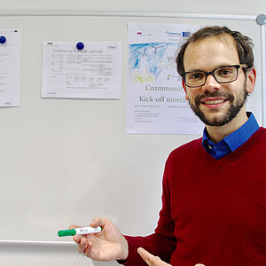 A young man with glasses and a beard standing n front of a white board | Co2mmunity | Interreg Baltic Sea Region