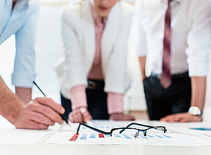Co workers at a table, glasses lying on papers in front | GoSmart BSR - a project of Interreg Baltic Sea Region (photo Panthermedia/Arne Trautmann)