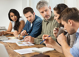 Five people in office wear sitting at a table and one man speaking| SNowMan - a project in Interreg Baltic Sea Region 