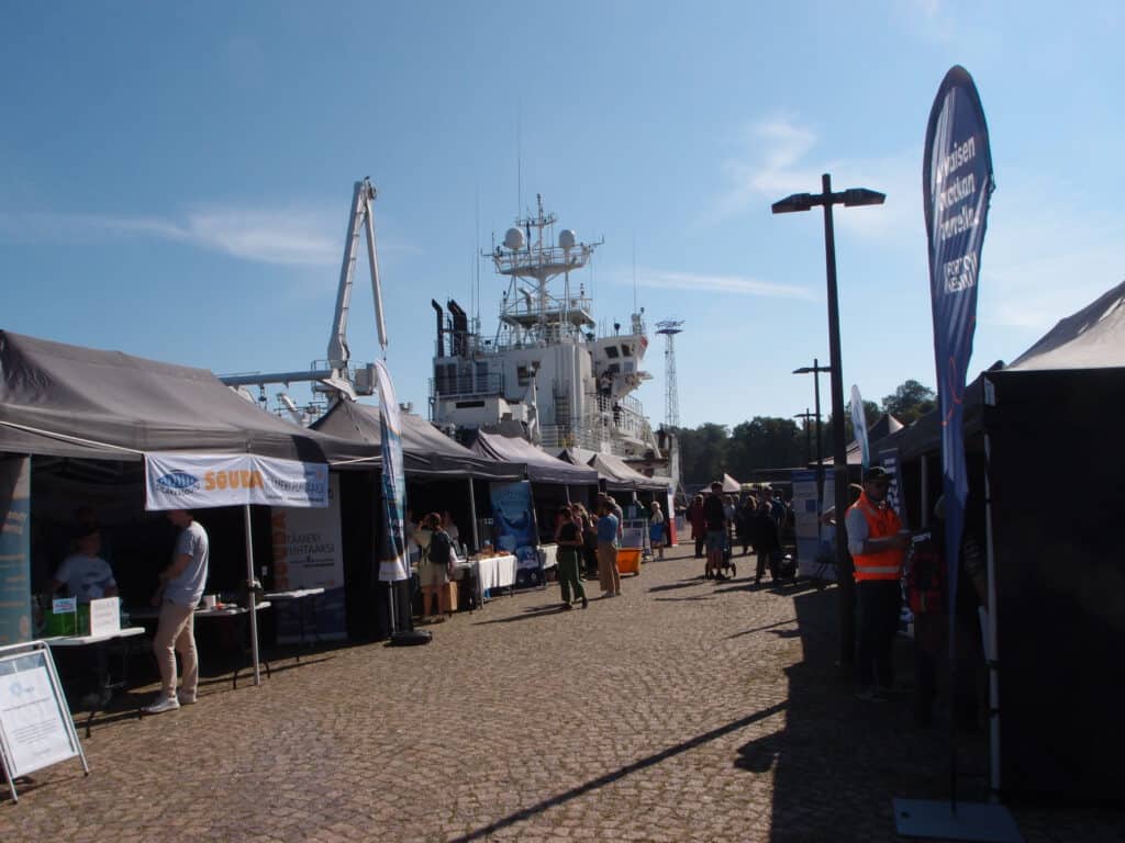 People visiting stakeholders' stands next to R/V Aranda