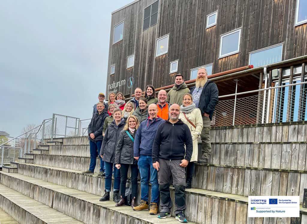 A group of people outside a wooden building