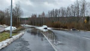 A car driving by a flooding.