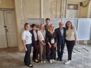 Conference participants standing at the front of the awarded GYPREG poster.