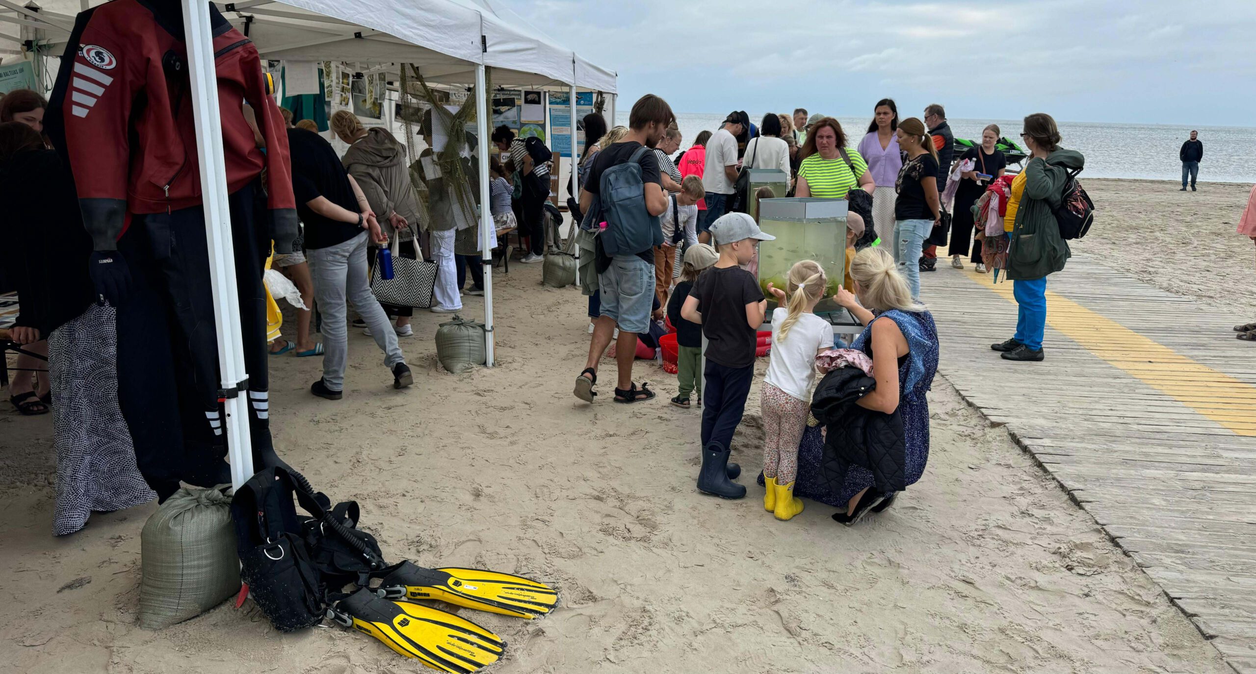 Sea Festival at the sandy beach of Liepaja: stands, people, aquarium, diving equipment...