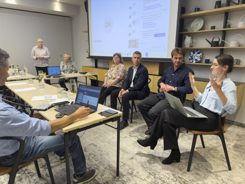 Panel discussion at seminar setting. Woman in the front is talking.