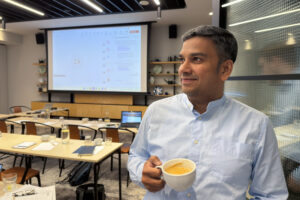 Man with cappuchino cup on seminar break