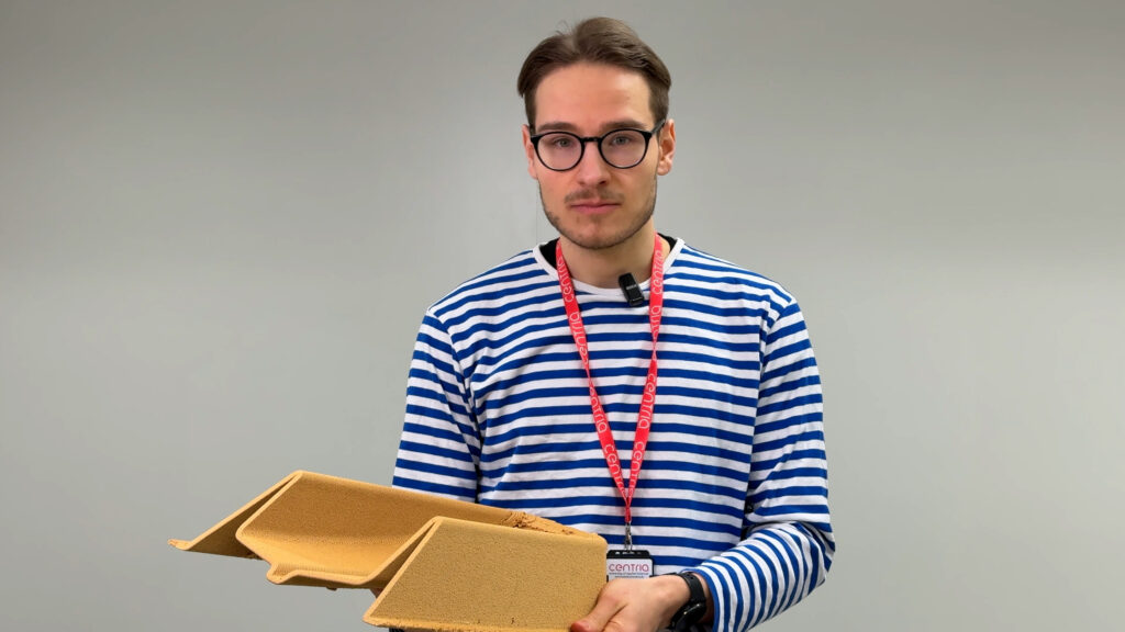 Project manager holds a piece of 3D-printed material