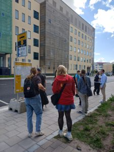 People standing at a bus stop.