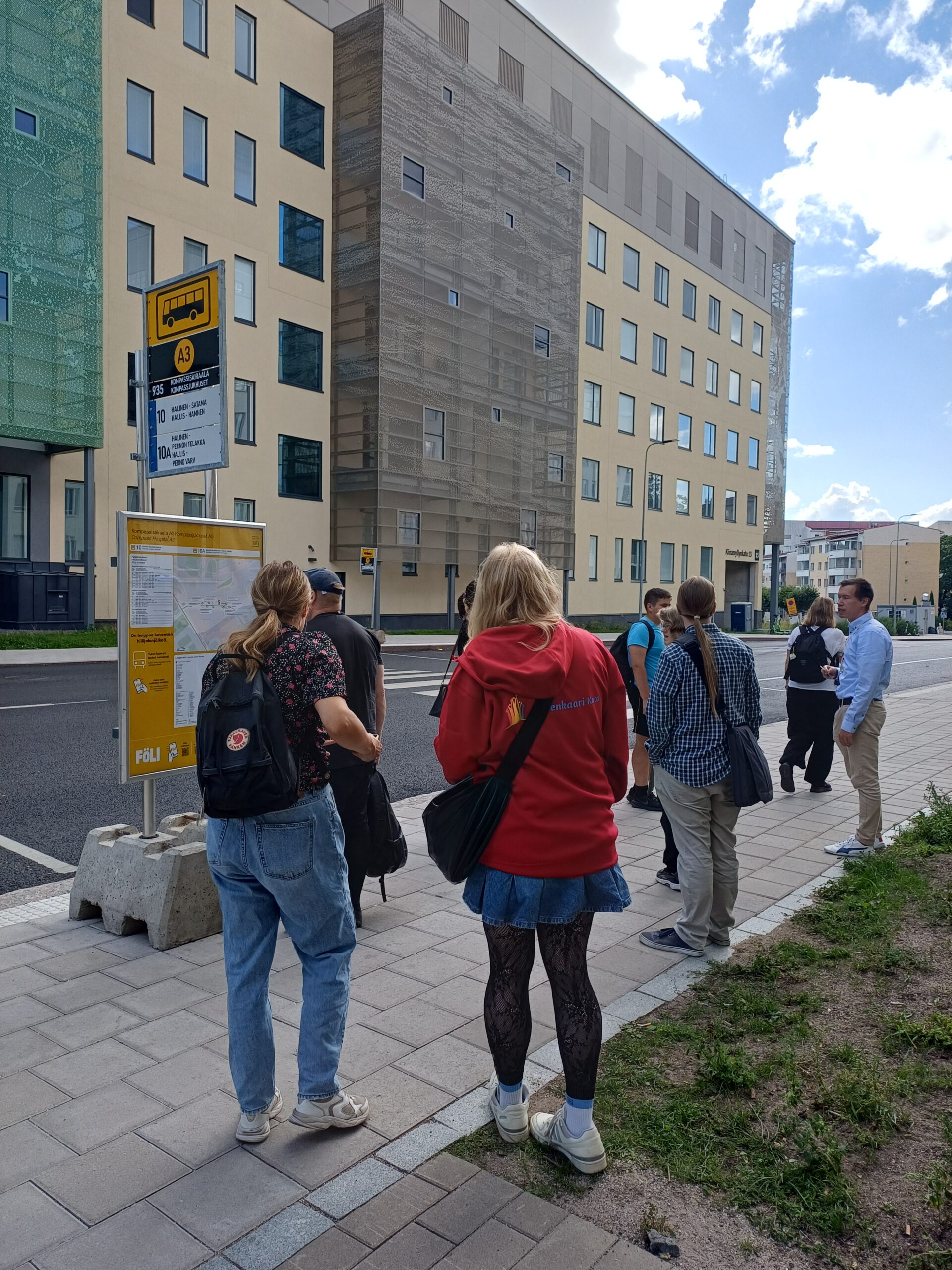 People standing at a bus stop.
