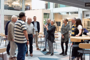 Members of BalticBlue in conversation standing in a semi-circle.