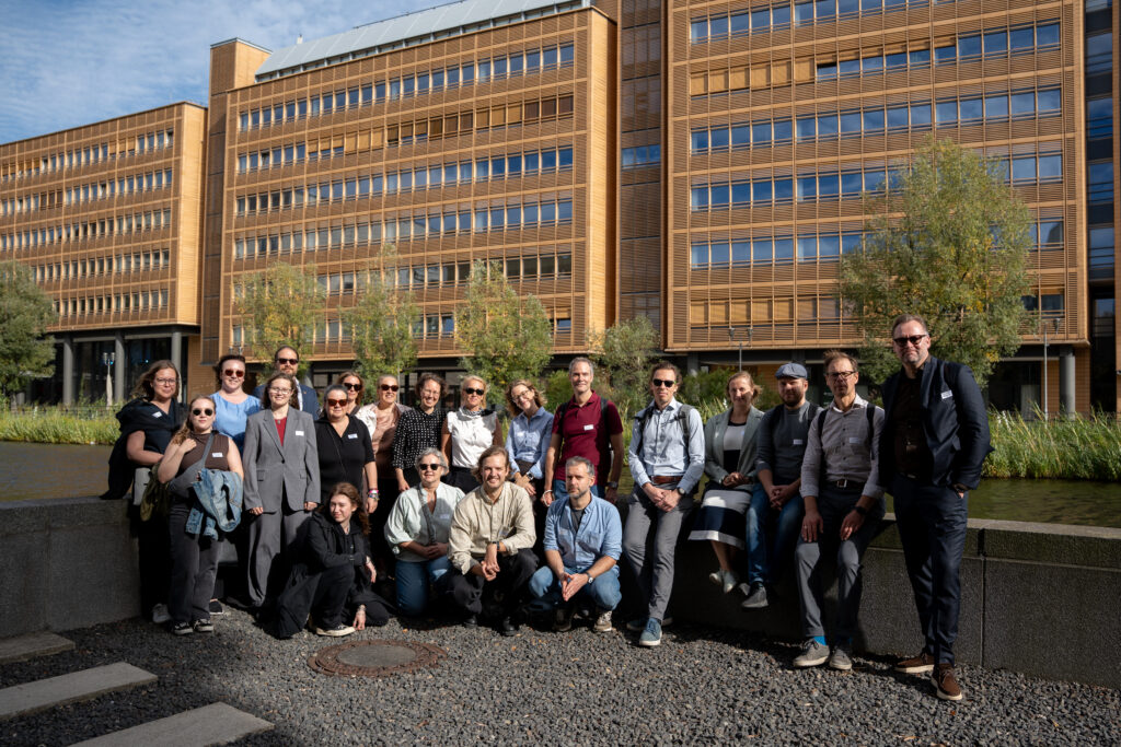 Group of people in front of a small lake in sunny Berlin.