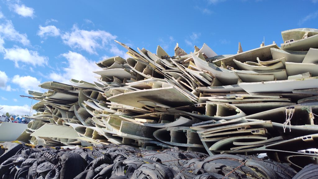 Scrapped wind turbine blades in a pile